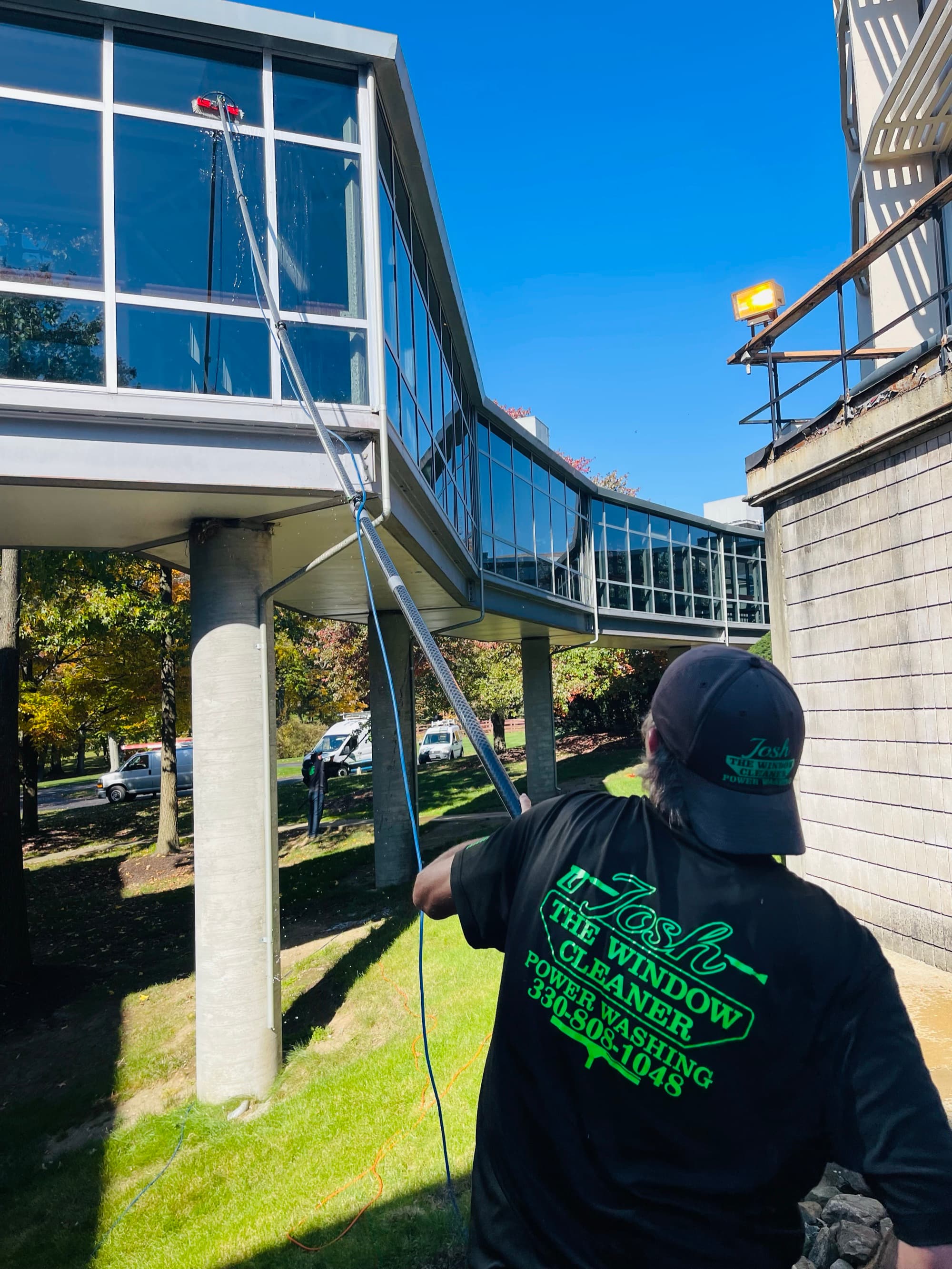 Technician using water-fed pole system