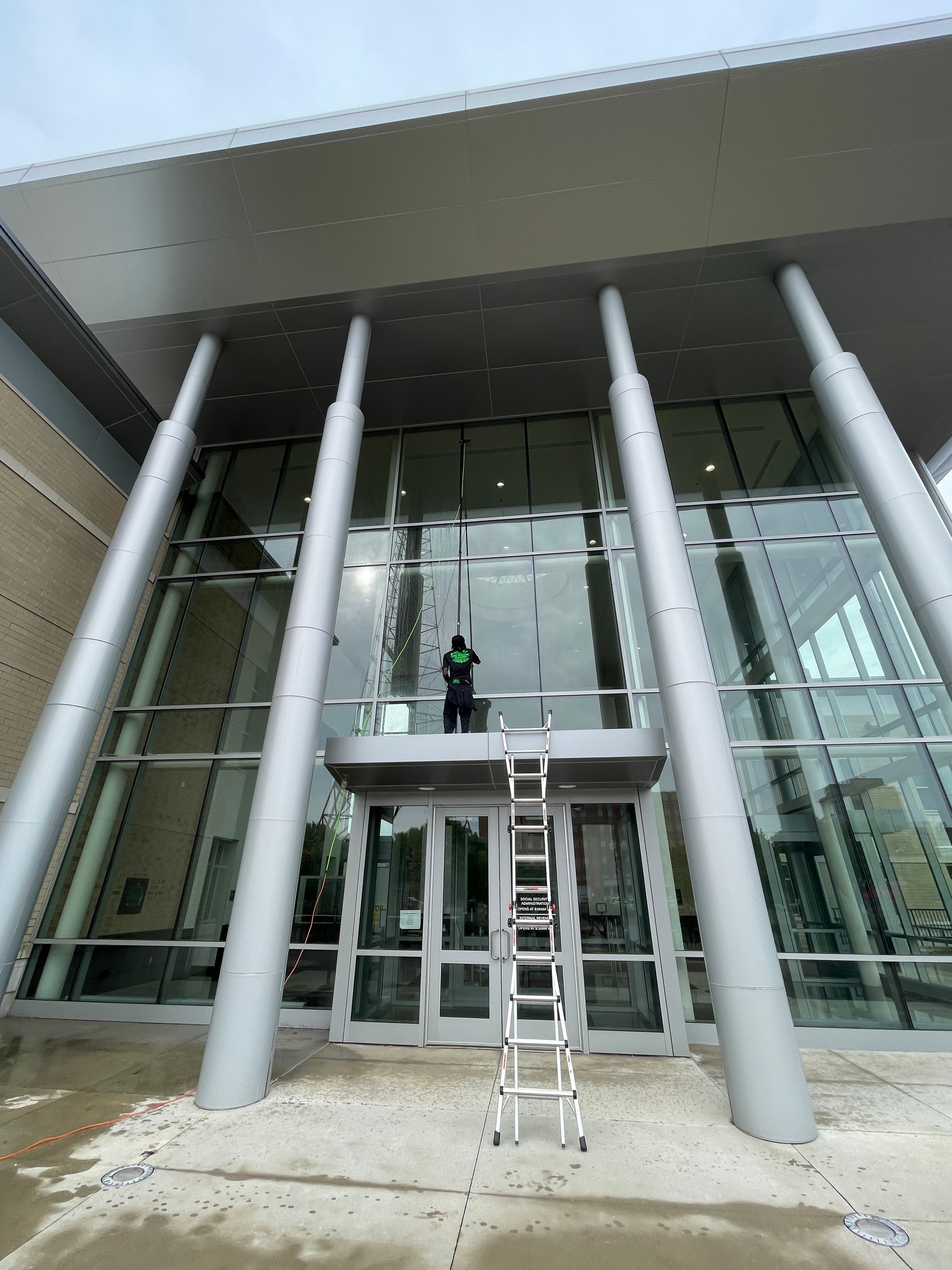 Worker cleaning commercial building windows